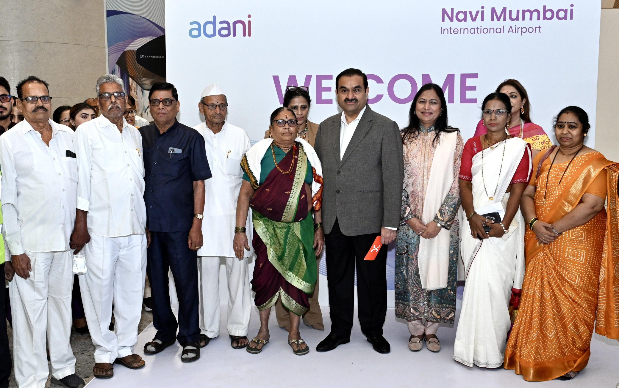 Gautam Adani personally welcomed passengers on the inaugural commercial flight at Navi Mumbai International Airport and interacted with frontline staff, airport workers, and first time flyers